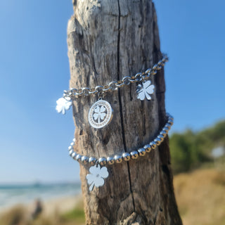 Bracciale acciaio maglia rolò con 2 quadrifogli pendenti e 1 centrale con pietre bianche