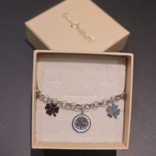 Bracciale acciaio maglia rolò con 2 quadrifogli pendenti e 1 centrale con pietre bianche