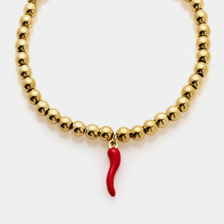 Bracciale acciaio dorato a sfere lucide e centrale pendente corno smaltato rosso